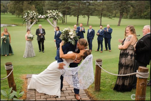 Groom Dipping Bride After Wedding Ceremony